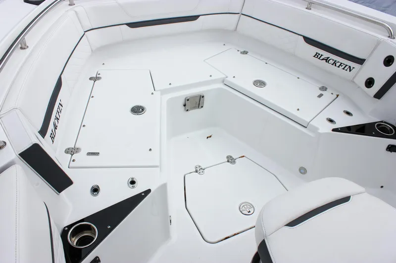 Irish Eyes Yacht Photos Pics 2023 Blackfin 252 CC boat interior with white seating and storage compartments.