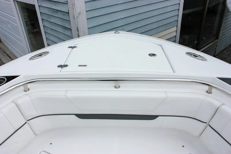 Irish Eyes Yacht Photos Pics 2023 Blackfin 252 CC boat bow with white seating and storage compartments.