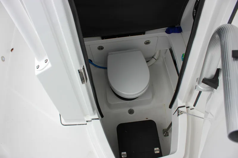 Irish Eyes Yacht Photos Pics 2023 Blackfin 252 CC boat interior with compact marine toilet.