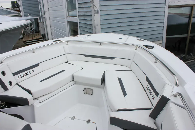 Irish Eyes Yacht Photos Pics 2023 Blackfin 252 CC boat interior with white cushioned seating and sleek design.