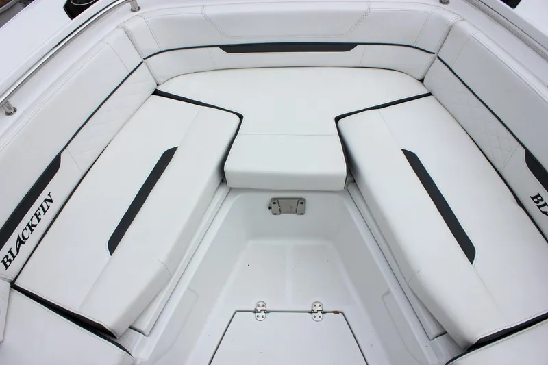 Irish Eyes Yacht Photos Pics 2023 Blackfin 252 CC boat interior with white cushioned seating.