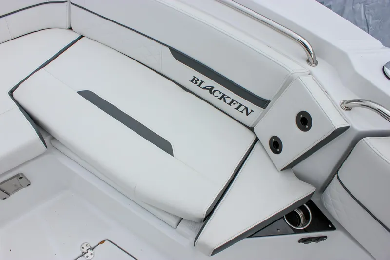 Irish Eyes Yacht Photos Pics 2023 Blackfin 252 CC boat interior seating with sleek white upholstery and branded logo.