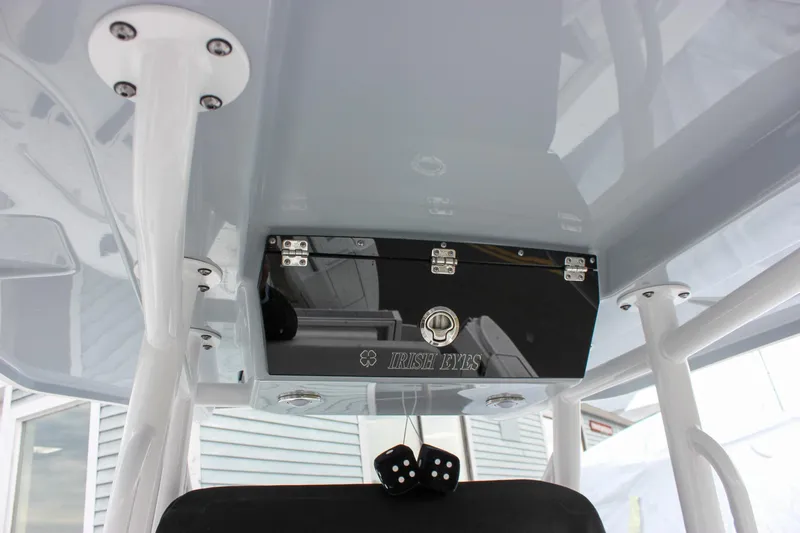 Irish Eyes Yacht Photos Pics 2023 Blackfin 252 CC boat console with storage compartment and sleek design.