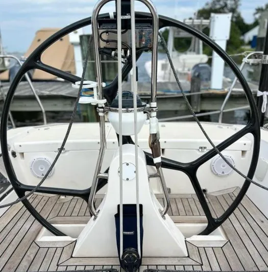 Sundog Yacht Photos Pics Steering wheel of a 2006 J Boats J/124 sailboat, docked at a marina.