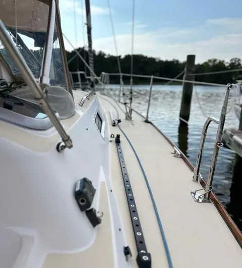 Sundog Yacht Photos Pics 2006 J Boats J/124 sailboat docked by the water on a sunny day.