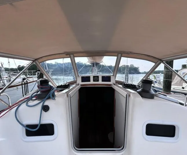 Sundog Yacht Photos Pics 2006 J Boats J/124 sailboat cockpit with canopy, docked at marina.
