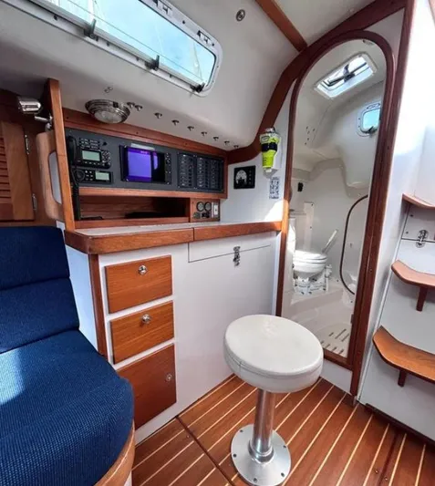 Sundog Yacht Photos Pics Interior of 2006 J Boats J/124 sailboat with navigation station and seating area.