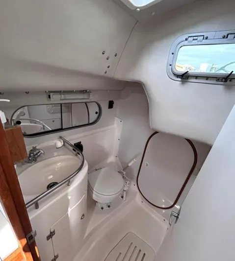 Sundog Yacht Photos Pics 2006 J Boats J/124 yacht bathroom with sink, toilet, and porthole window.