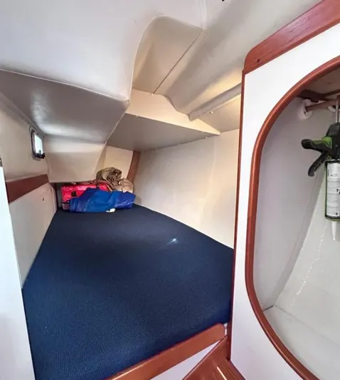 Sundog Yacht Photos Pics Interior cabin of 2006 J Boats J/124, featuring a cozy sleeping area and storage.