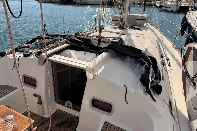  Yacht Photos Pics Beneteau Oceanis 370 sailboat, 2013 model, docked at marina with sunlit deck.
