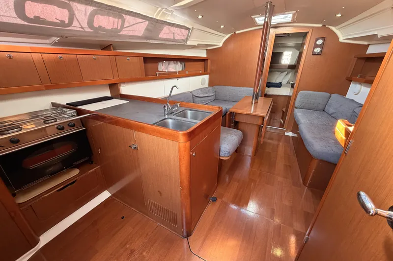  Yacht Photos Pics Interior of 2013 Beneteau Oceanis 370 yacht with kitchen and seating area.