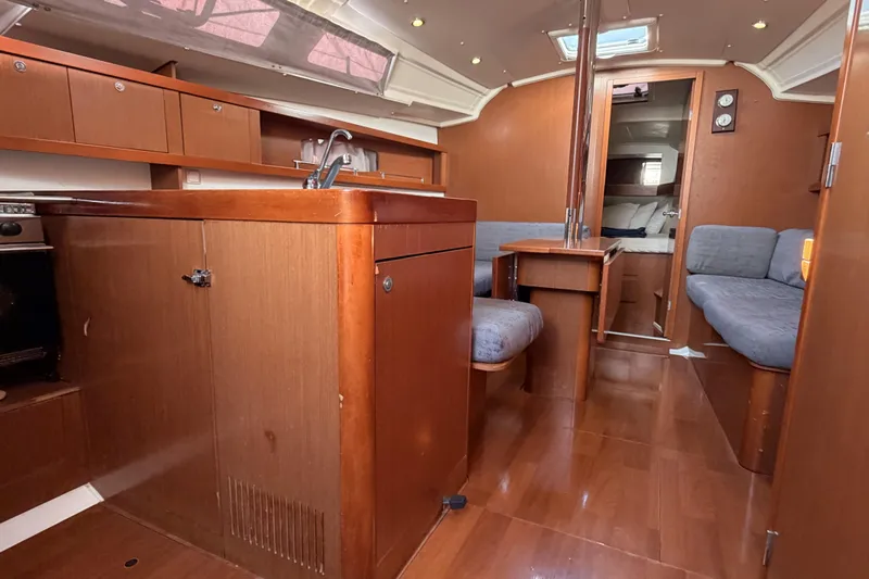  Yacht Photos Pics Interior of 2013 Beneteau Oceanis 370 yacht with wood finish and seating area.