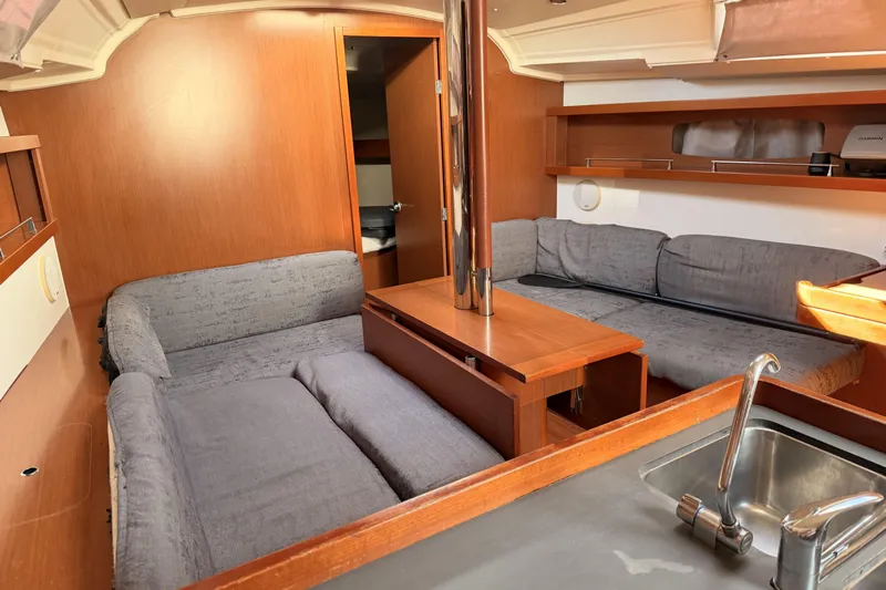  Yacht Photos Pics Interior of 2013 Beneteau Oceanis 370 yacht with cozy seating and wooden finishes.