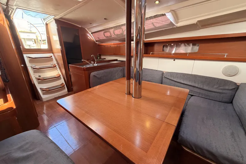  Yacht Photos Pics Interior of 2013 Beneteau Oceanis 370 sailboat with wood finish and cozy seating area.