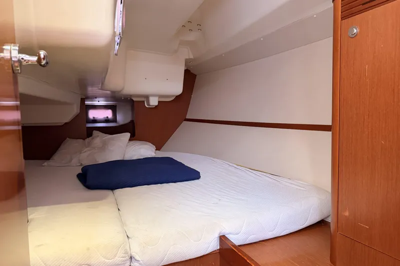  Yacht Photos Pics Cozy cabin interior of 2013 Beneteau Oceanis 370 sailboat with comfortable bedding.