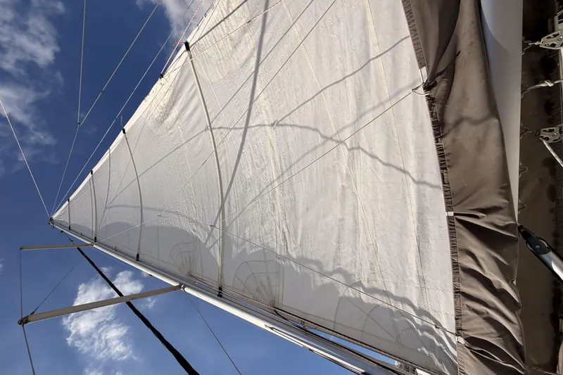  Yacht Photos Pics Sail of a 2013 Beneteau Oceanis 370 against a clear blue sky.