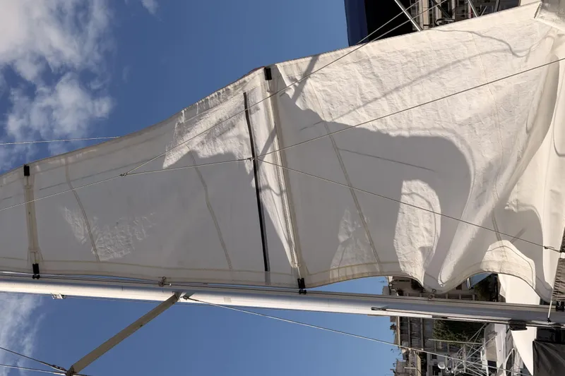  Yacht Photos Pics Sail of a 2013 Beneteau Oceanis 370 yacht against a clear blue sky.