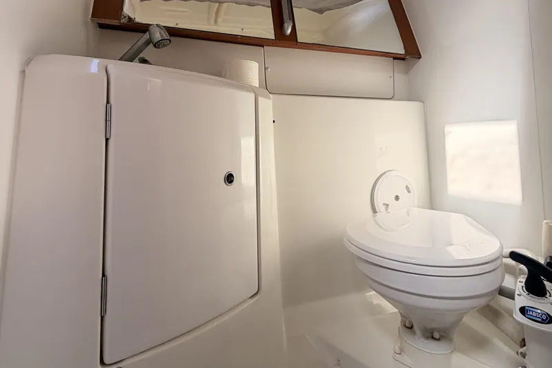  Yacht Photos Pics Bathroom of 2013 Beneteau Oceanis 370 yacht with toilet and storage cabinet.