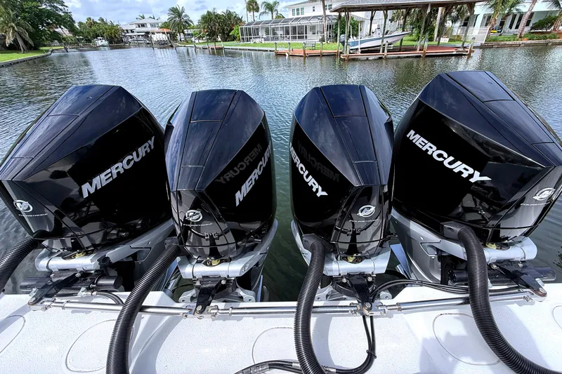 Hot Rod Yacht Photos Pics 2022 Yellowfin 39 Offshore boat with four Mercury outboard engines on a calm waterway.