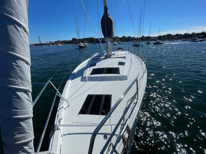 In Stock Yacht Photos Pics 2024 Hanse 410 sailboat on sparkling water, sunny day, marina background.