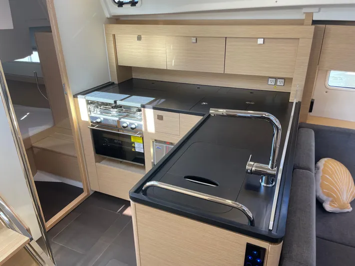 In Stock Yacht Photos Pics Modern kitchen interior of 2024 Hanse 410 yacht with sleek cabinetry and appliances.