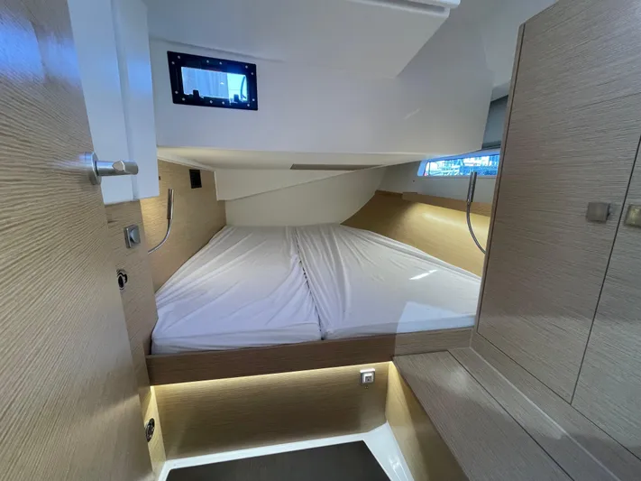 In Stock Yacht Photos Pics 2024 Hanse 410 yacht cabin with modern design and cozy bedding.