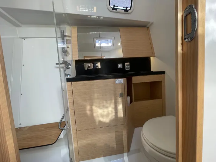 In Stock Yacht Photos Pics Modern bathroom interior of 2024 Hanse 410 yacht with wood accents and sleek fixtures.