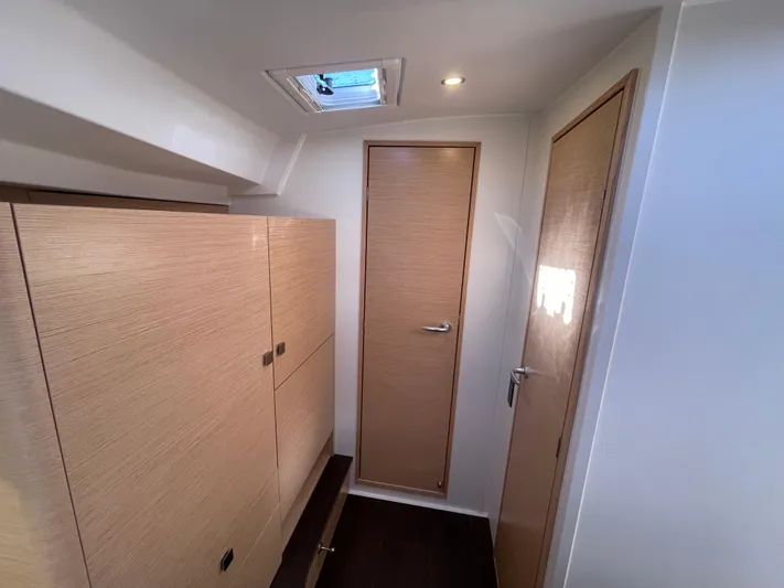 In Stock Yacht Photos Pics 2024 Hanse 410 yacht interior with wooden cabinetry and doors.