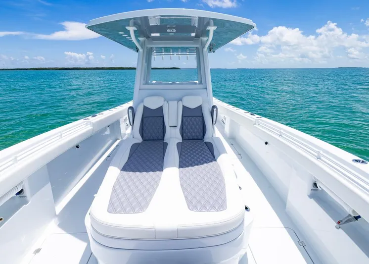  Yacht Photos Pics 2026 Invincible 33 Catamaran on clear blue water, featuring sleek seating and modern design.