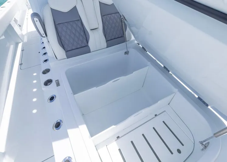  Yacht Photos Pics 2026 Invincible 33 Catamaran storage compartment with cushioned seating and rod holders.