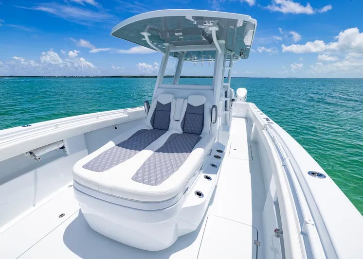  Yacht Photos Pics 2026 Invincible 33 Catamaran on clear blue water, showcasing sleek design and spacious deck.