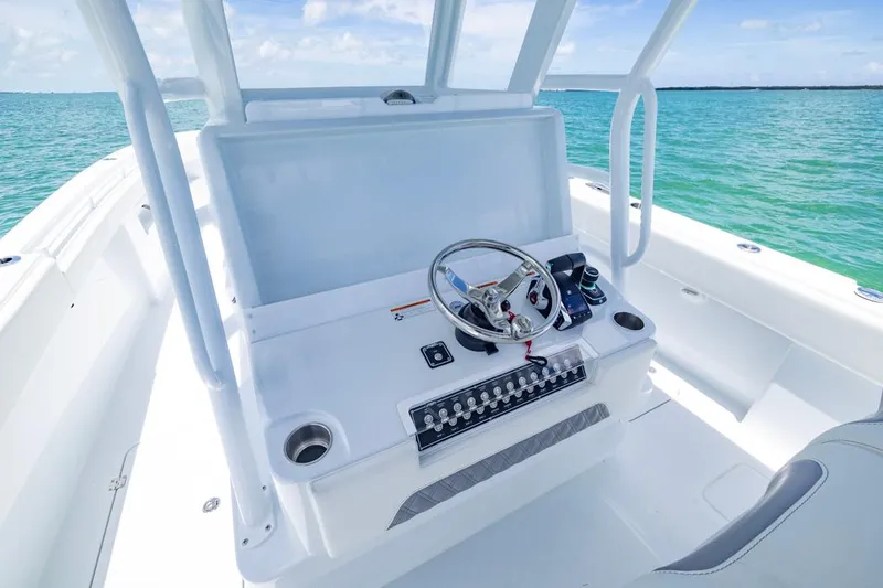  Yacht Photos Pics 2026 Invincible 33 Catamaran helm with steering wheel, controls, and ocean view.