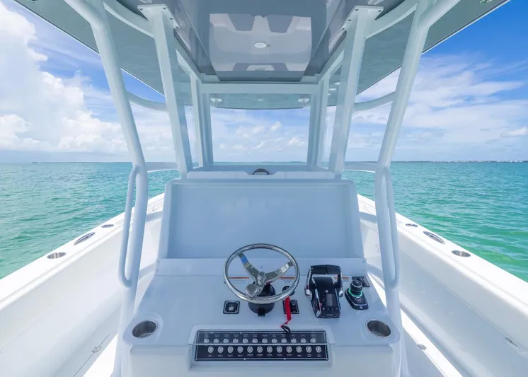  Yacht Photos Pics 2026 Invincible 33 Catamaran helm with ocean view, featuring modern controls and steering wheel.