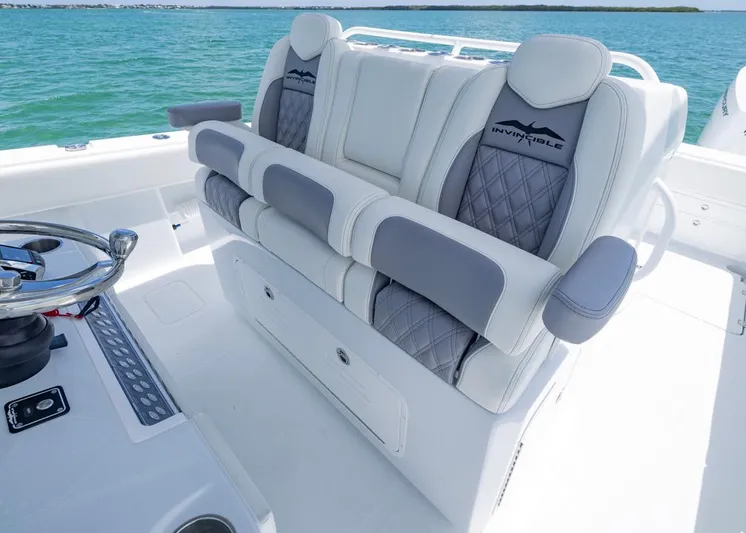  Yacht Photos Pics 2026 Invincible 33 Catamaran interior with luxurious seating and steering wheel, on open water.
