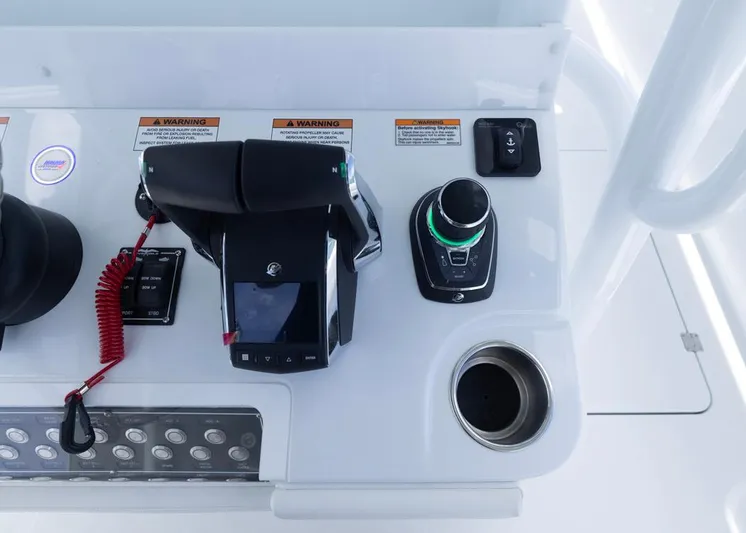  Yacht Photos Pics Control panel of 2026 Invincible 33 Catamaran with throttle, joystick, and warning labels.