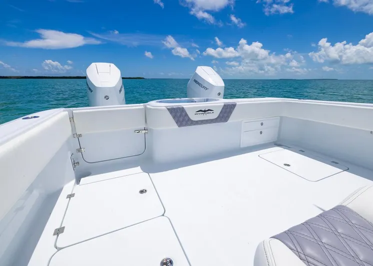  Yacht Photos Pics 2026 Invincible 33 Catamaran on open water, featuring spacious deck and twin Mercury engines.