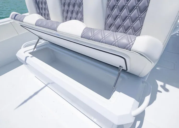  Yacht Photos Pics 2026 Invincible 33 Catamaran seat storage with quilted upholstery, open compartment.