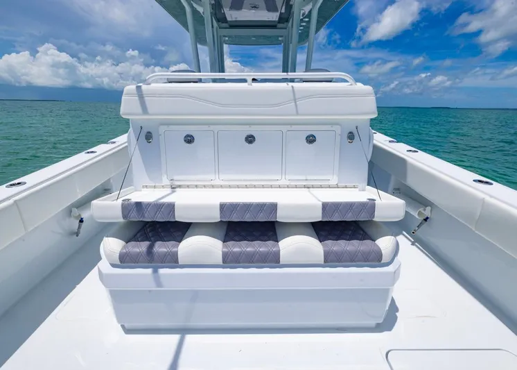  Yacht Photos Pics 2026 Invincible 33 Catamaran interior with cushioned seating, ocean view, and clear blue sky.