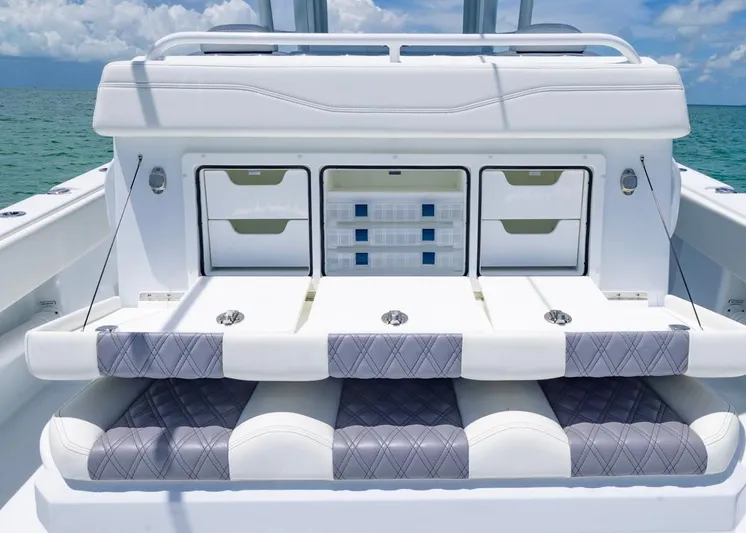  Yacht Photos Pics 2026 Invincible 33 Catamaran interior with storage compartments and cushioned seating.