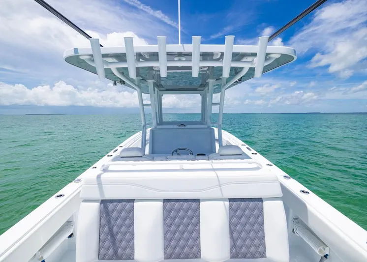  Yacht Photos Pics Invincible 33 Catamaran 2026 on open sea with clear skies and turquoise water.