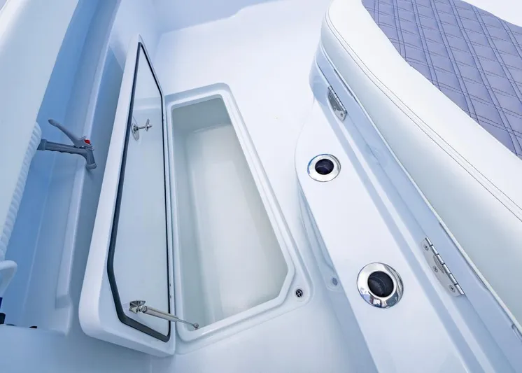  Yacht Photos Pics 2026 Invincible 33 Catamaran interior storage compartment with open hatch and seating.