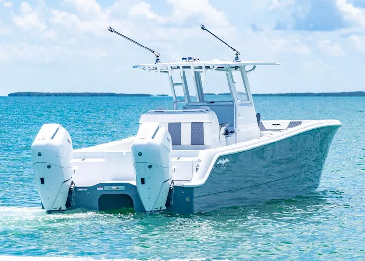  Yacht Photos Pics 2026 Invincible 33 Catamaran on clear blue water, showcasing twin engines and sleek design.