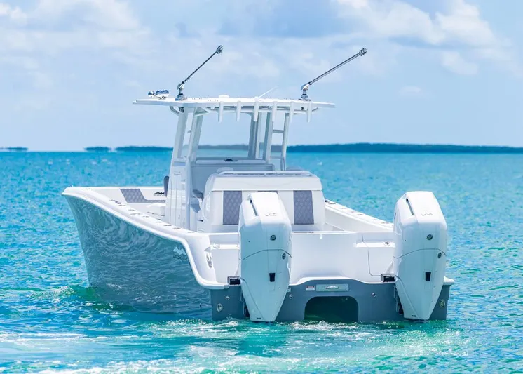  Yacht Photos Pics 2026 Invincible 33 Catamaran on clear blue water, rear view.