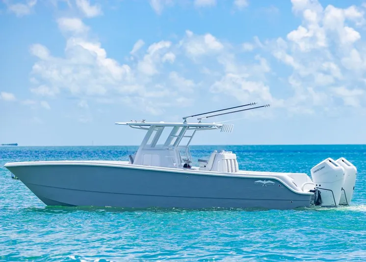  Yacht Photos Pics 2026 Invincible 33 Catamaran on clear blue ocean under a sunny sky.