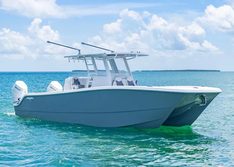 Yacht Photos Pics 2026 Invincible 33 Catamaran on clear blue ocean under a bright sky.