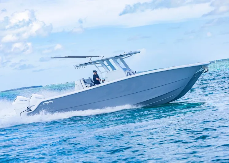  Yacht Photos Pics 2026 Invincible 33 Catamaran cruising on blue ocean waters under a clear sky.