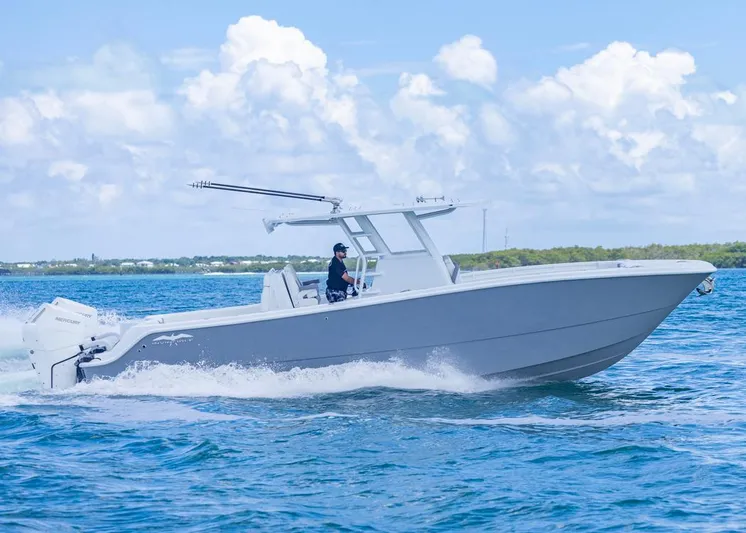  Yacht Photos Pics 2026 Invincible 33 Catamaran cruising on blue ocean under clear sky.