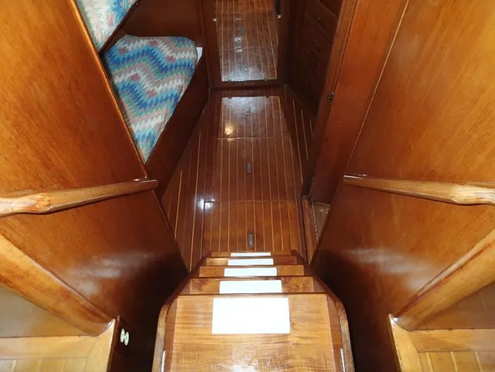 Southern Cross Yacht Photos Pics Wooden interior stairs of 1987 Tayana 45 Expedition Trawler with polished finish.