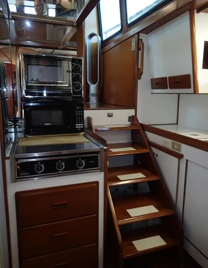 Southern Cross Yacht Photos Pics Interior of 1987 Tayana 45 Expedition Trawler with kitchen and wooden stairs.