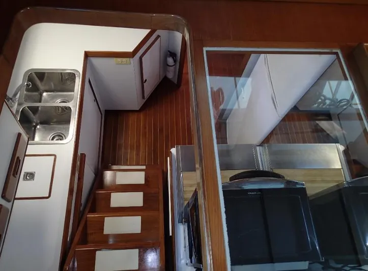 Southern Cross Yacht Photos Pics Interior of 1987 Tayana 45 Expedition Trawler with wooden stairs and dual sinks.